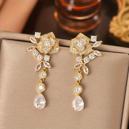 A pair of gold plated jewelry with floral zirconia tassels and creative design. The earrings are elegant, fashionable, minimalist, and versatile, making them an excellent choice for girls and women to wear at daily gift giving parties MyFave Boutique